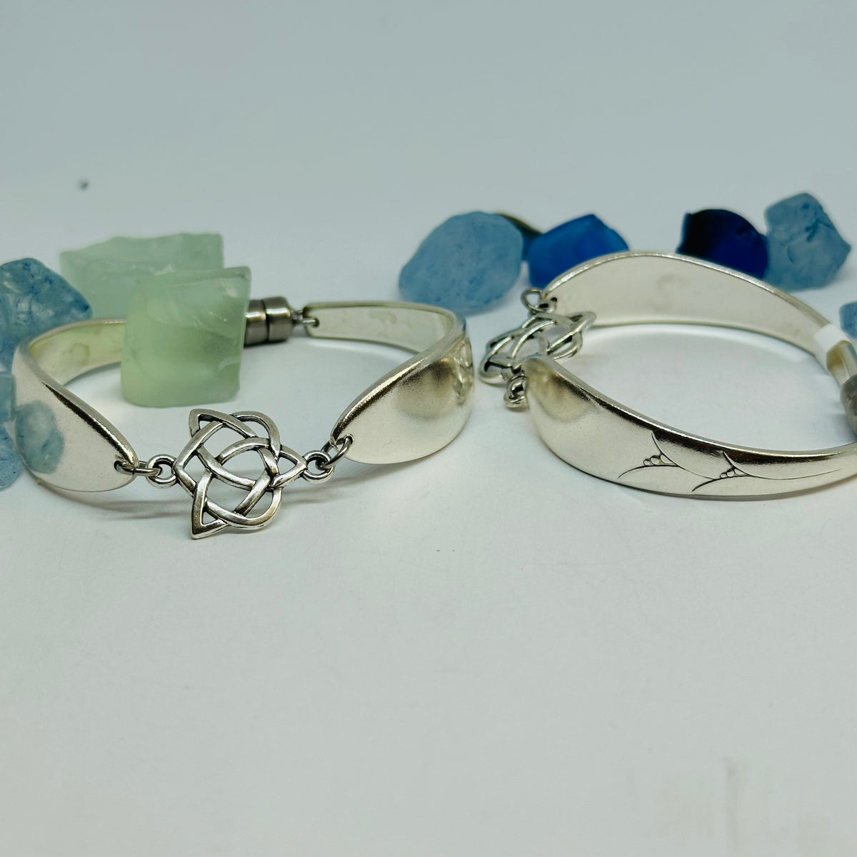 Two Lady Hamilton 1932 vintage spoon bracelets: one with a Trinity Knot charm, one showing the etched spoon bowl.