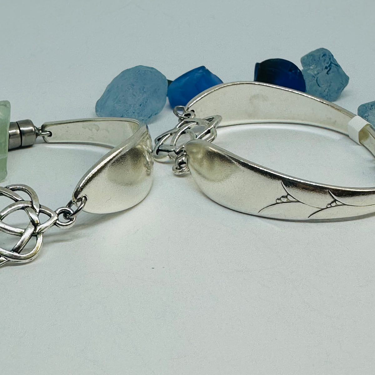 Close-up of two Lady Hamilton 1932 vintage spoon bracelets, one showing an etched spoon bowl detail.