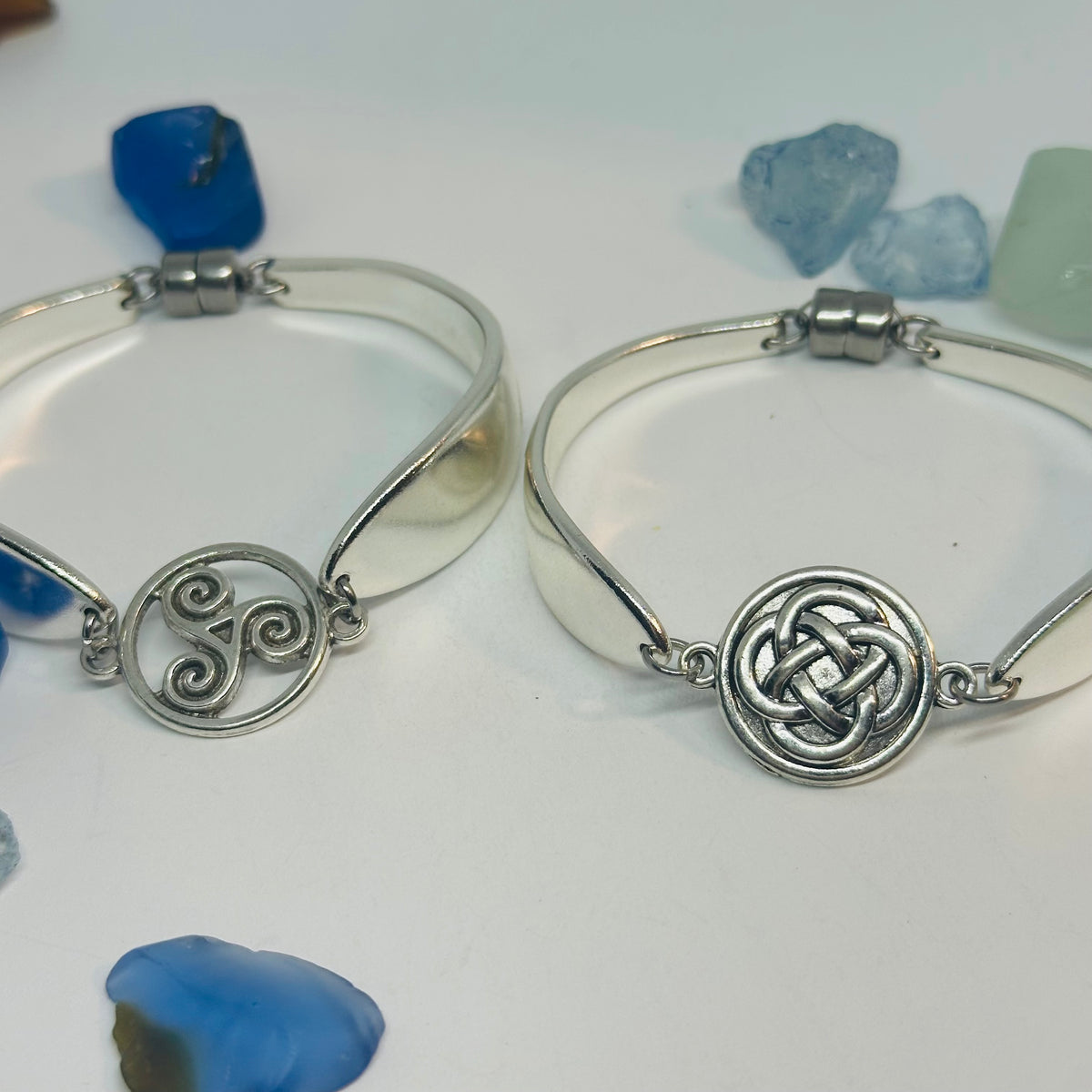 Two Lady Hamilton 1932 vintage spoon bracelets, one with a triskele charm and one with a Celtic knot charm.