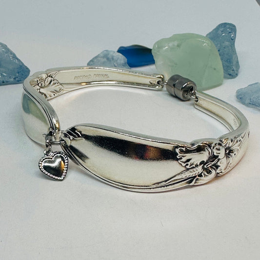 White Orchid 1953 silverplate spoon bracelet with heart charm and floral motif with magnetic clasp and stainless steel jump rings.